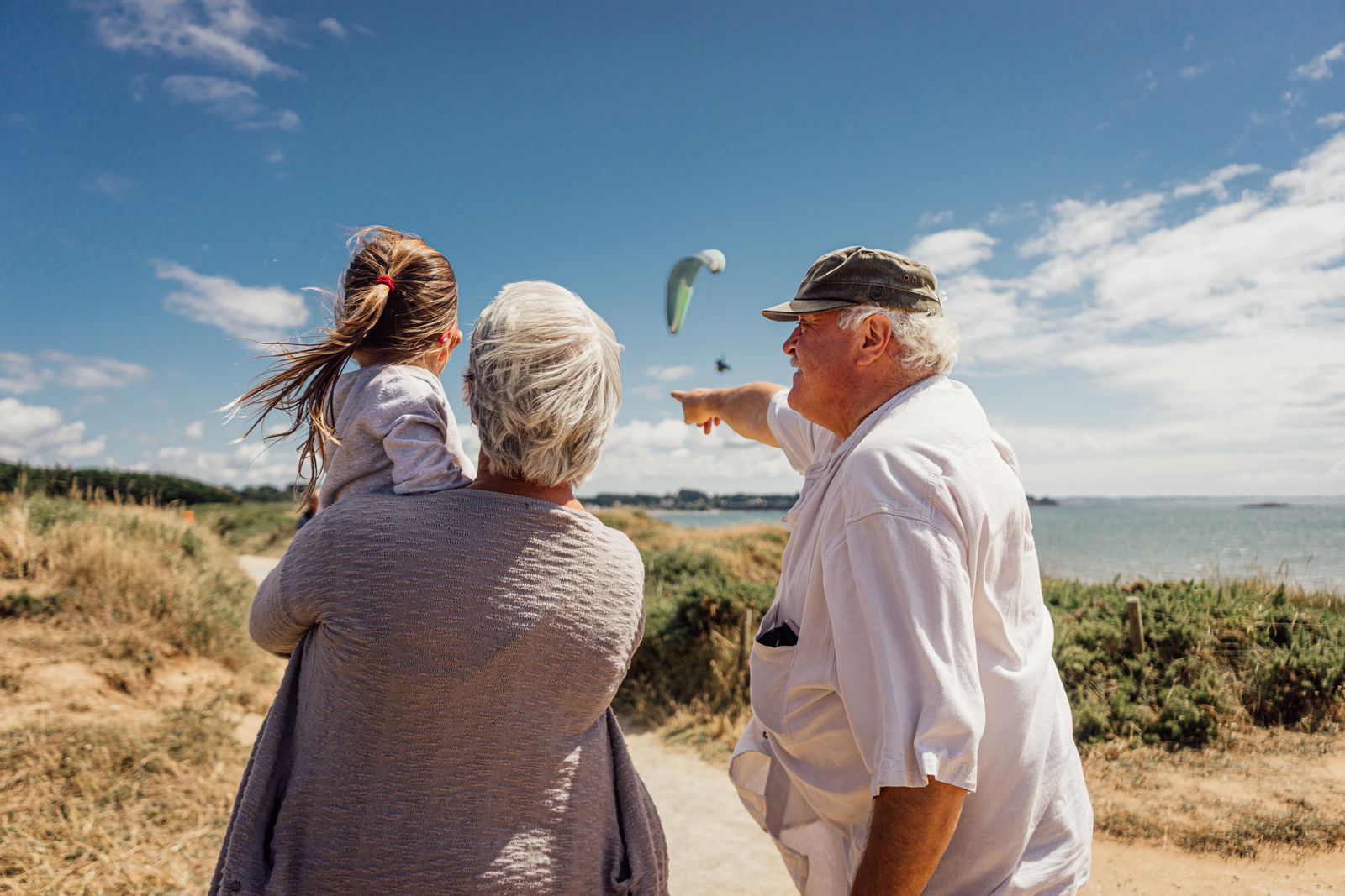 Grandparents and granddaughter on a seaside family trip